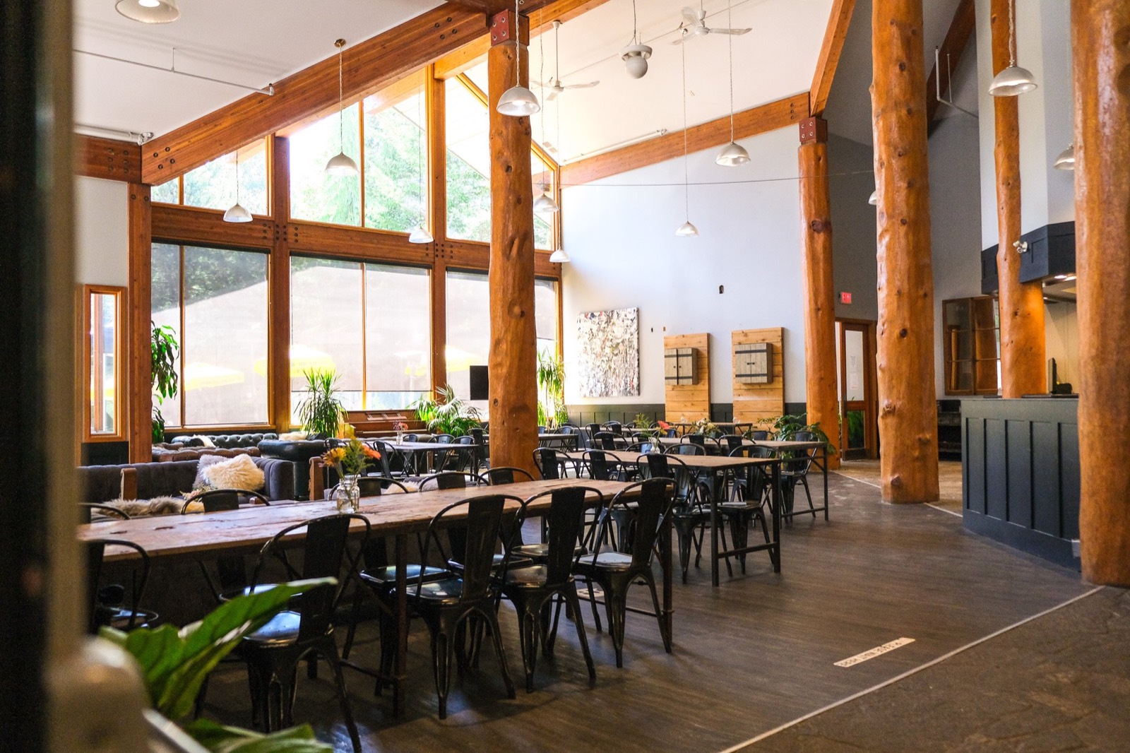 The lounge at the Whistler Racket Club, with timber beams and long tables